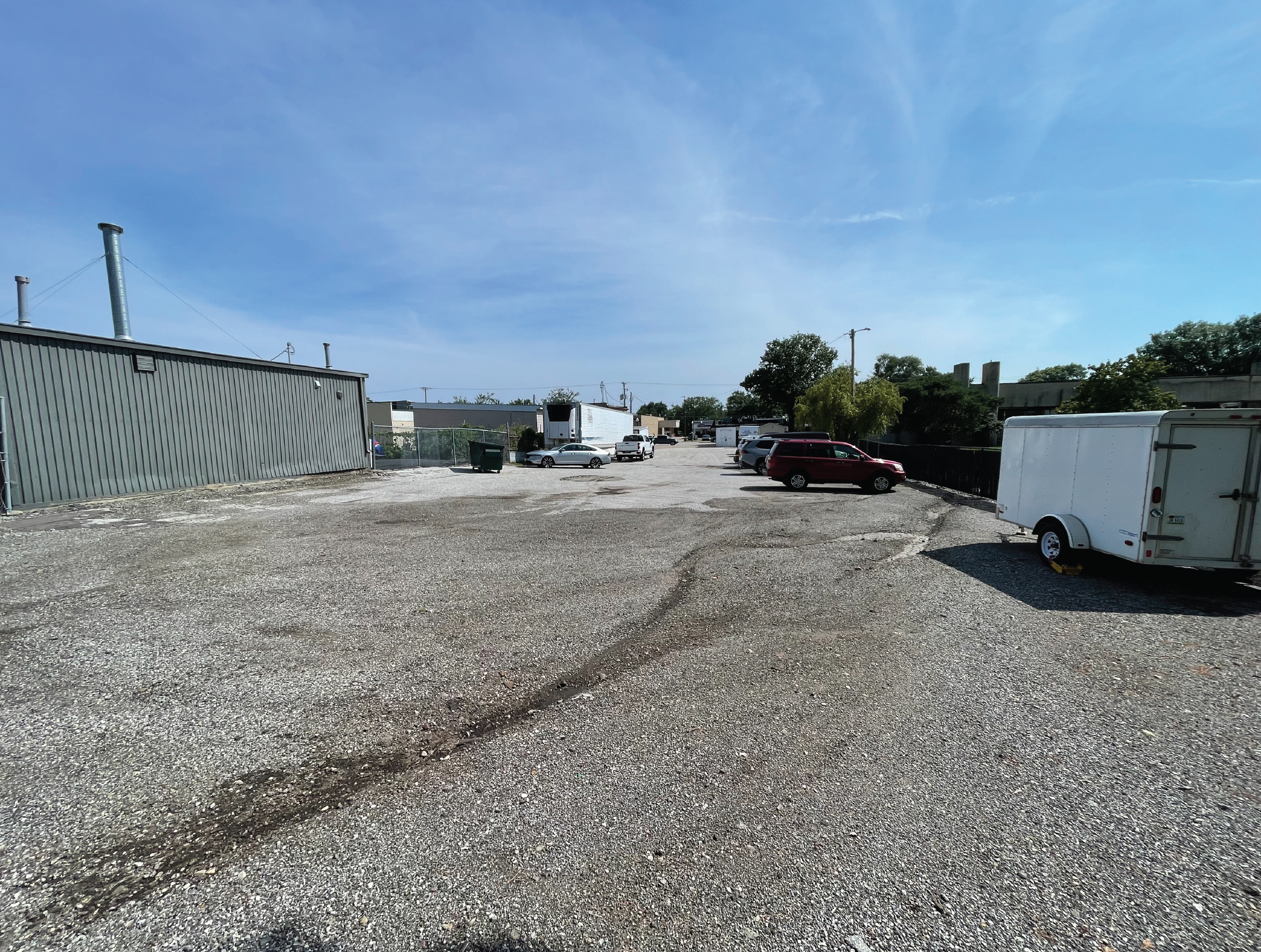 Downtown parking lot with no grass or trees and cars parked