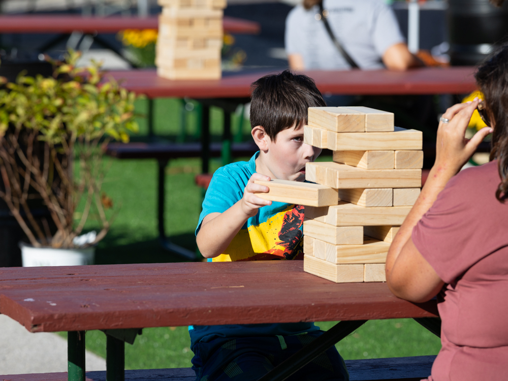 Young child playing oversized jenga