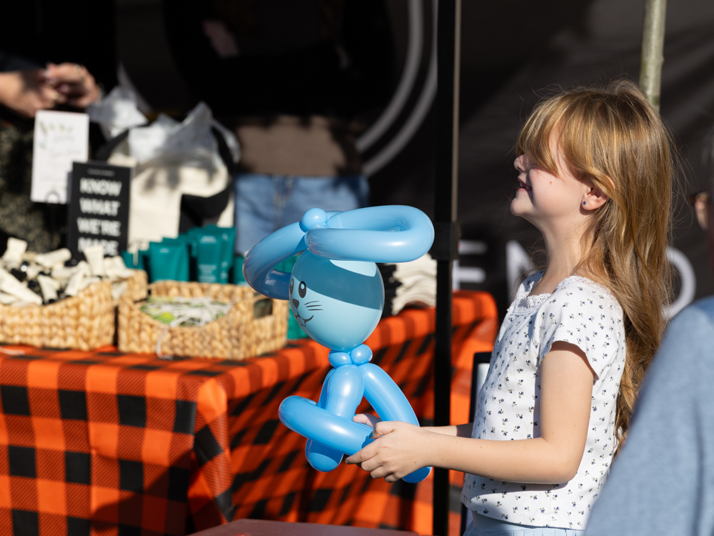 Young child holding a balloon creation