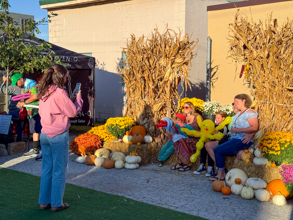 Family posing with fall decorations at the Downtown Urbandale Block Party