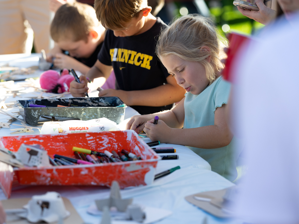 Group of children doing arts and crafts at the Downtown Urbandale Block Party