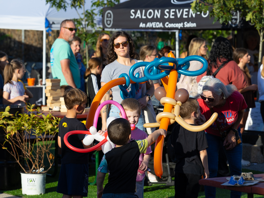 Children holding balloon creations at the Downtown Urbandale Block Party