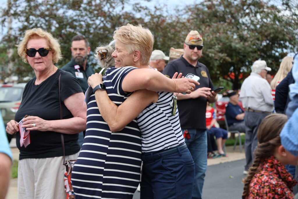 mural-ribbon-cutting-attendees-share-a-hug
